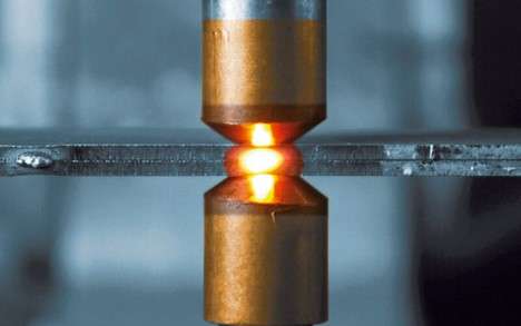Copper electrodes create a spot weld.