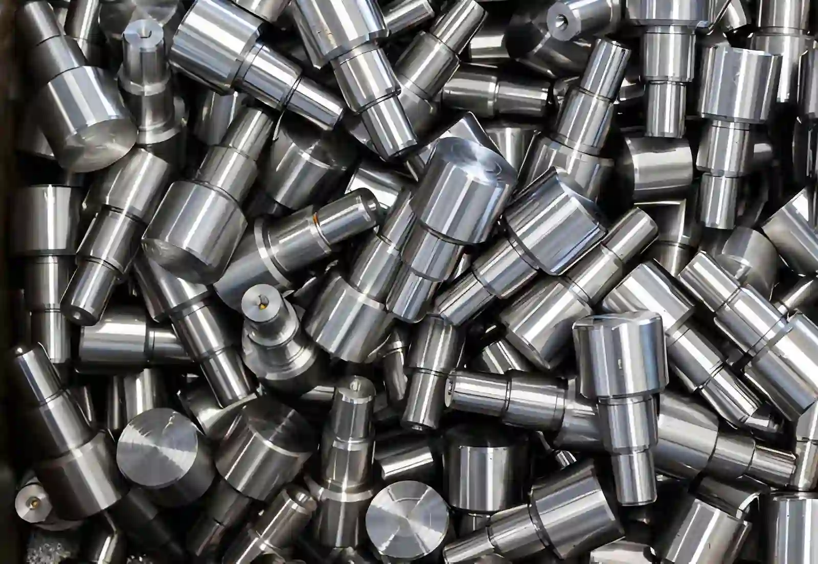 A heap of stainless steel turned pins and studs with a clean bright finish after passivation