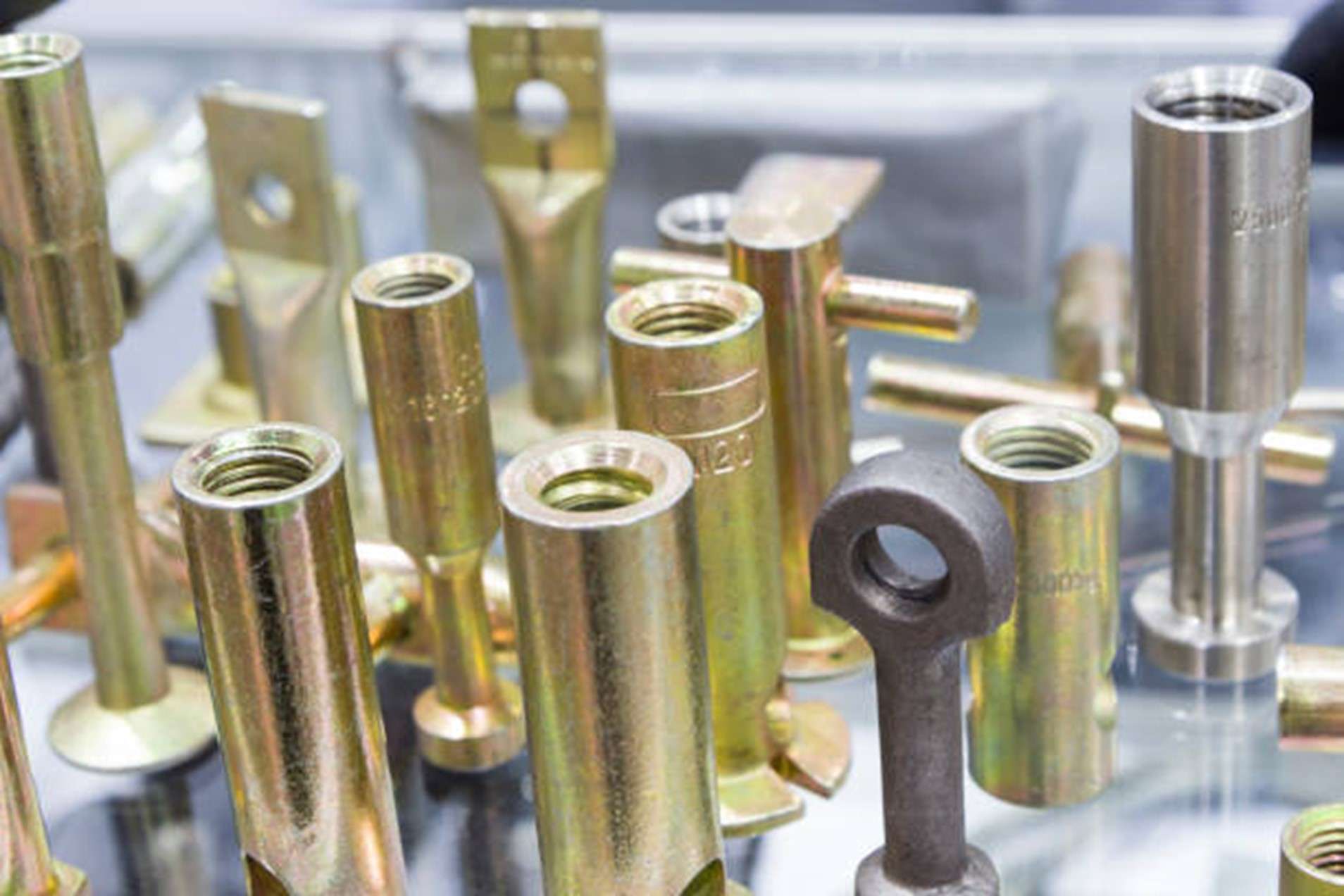 Zinc-plated metal parts laid out together with a uniform grey finish
