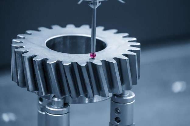 A CMM probe touching the surface of the gear during the measurement