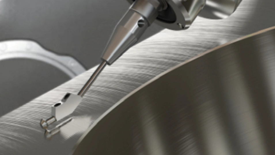 A surface roughness analysis machine probe contacting the surface of a CNC machined metal part 