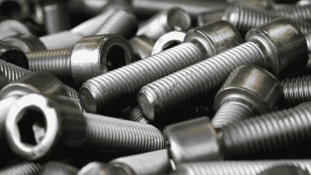 Image showing same-shaped threaded automotive fasteners arranged in order.