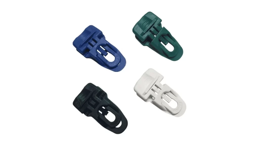 Four colorful clip holders of the same shape are shown together.