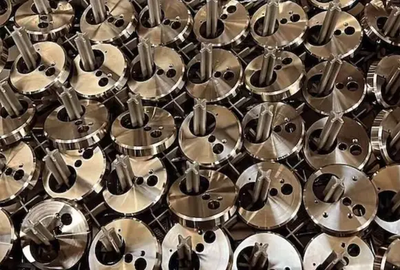 High-volume production of precision CNC-machined metal components with shafts and circular flanges.