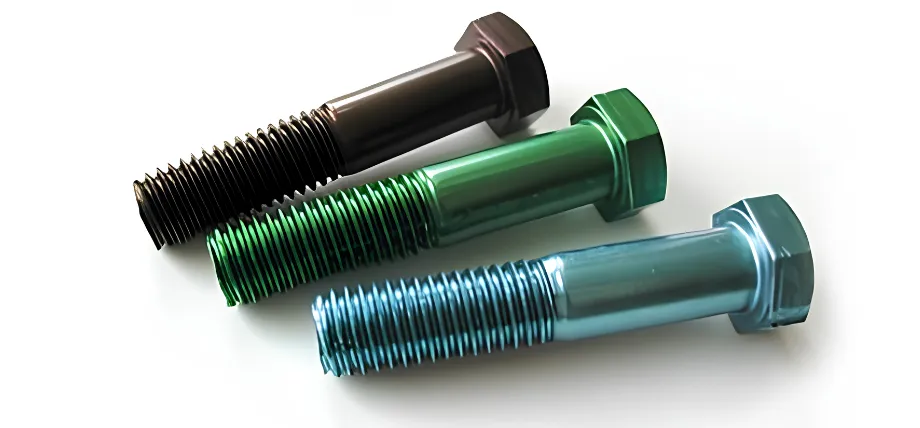 Three large hexagonal bolts in black, green, and blue finishes arranged diagonally on a white surface.