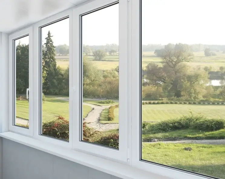 An image of a lawn view via a transparent glass window 