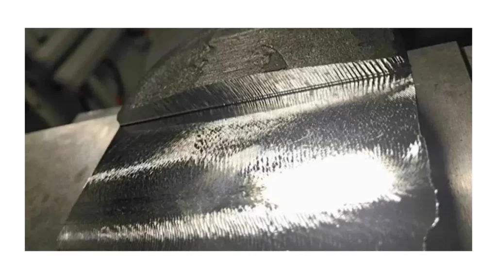 A close-up of a machined metal surface showing visible chatter marks and irregularities.