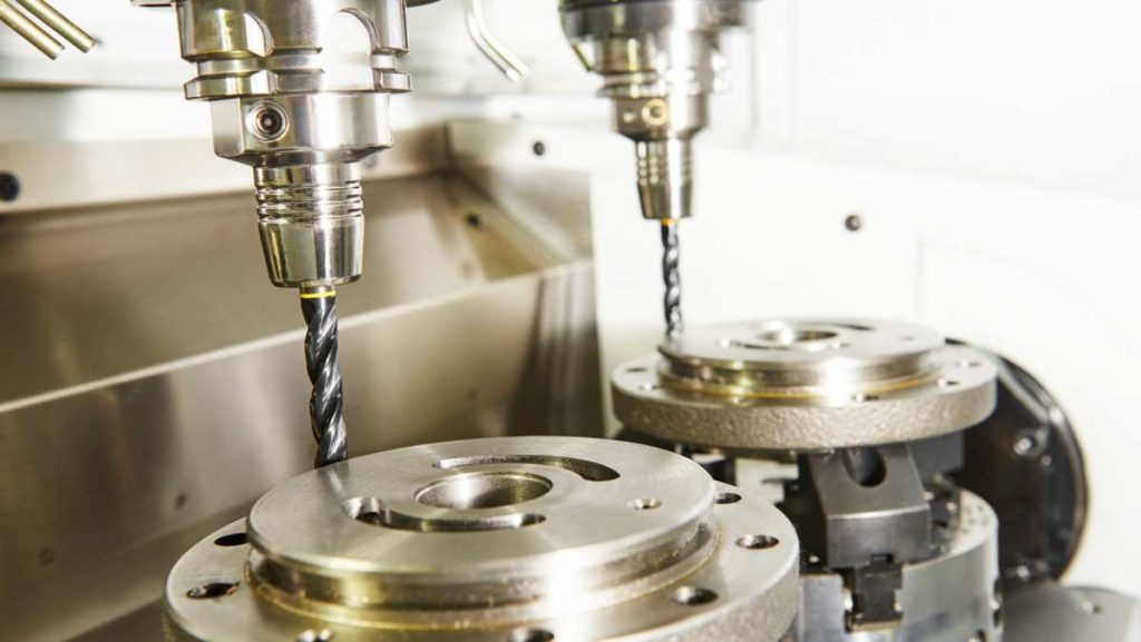 Two drills offset from workpiece centers.