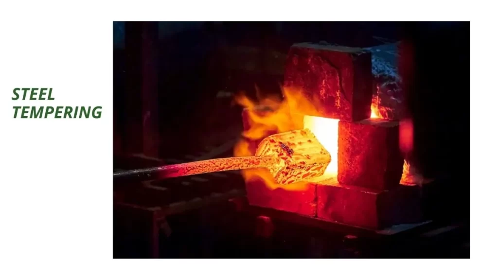Close-up of a metal component undergoing the tempering process with visible heat-treated surface.
