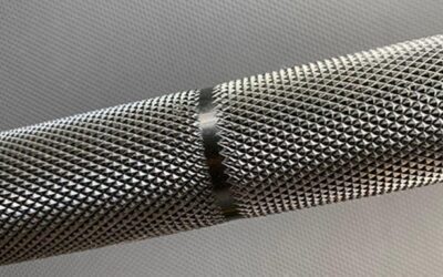 Close-up view of a metallic textured surface (Knurling service) with a slight separation in the middle