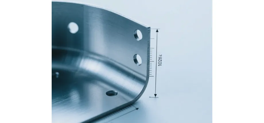 Close-up of a precisely bent stainless steel component with punched holes and measured bend radius of 2.0 mm, demonstrating high-quality sheet metal fabrication.