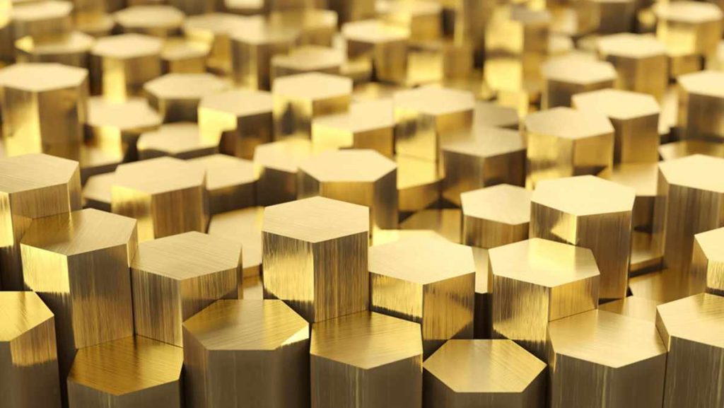 Many shiny golden hexagonal brass bars.