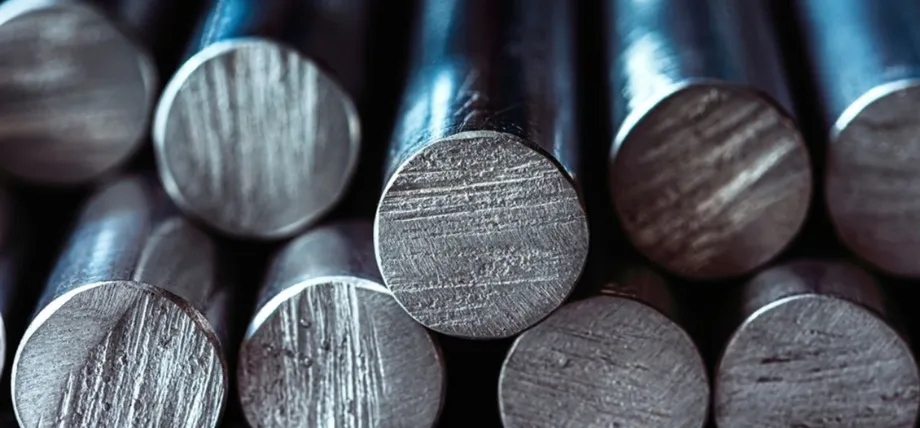 A close-up view of multiple polished aluminum alloy bars stacked together