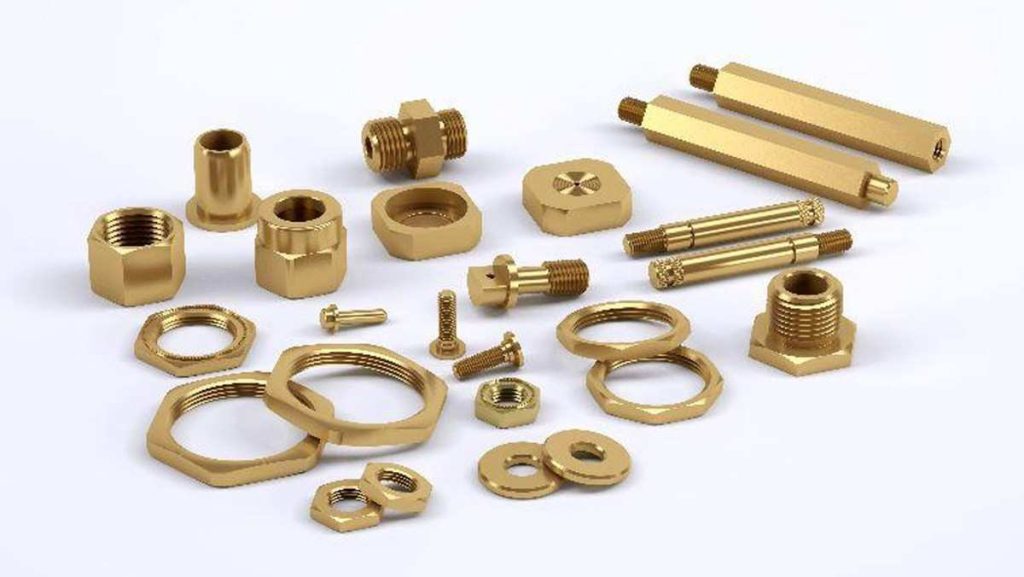Assortment of shiny golden brass fasteners and fittings.