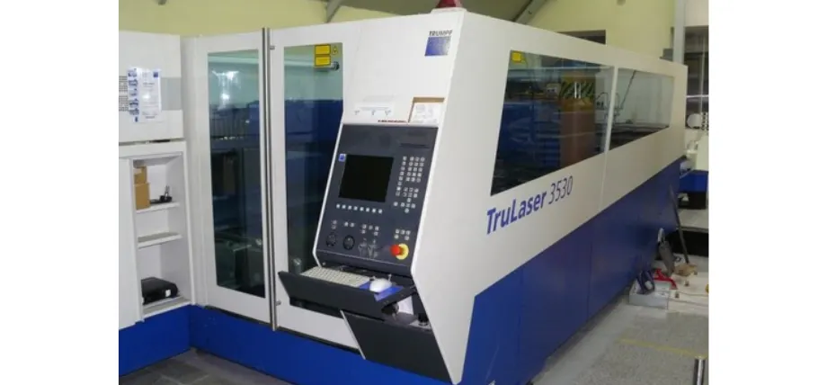 Trumpf TruLaser 3530 industrial laser cutting machine with control console and safety glass enclosure.