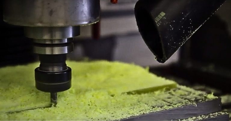 A CNC end mill cutting a stack of G10 FR4 fibreglass-epoxy laminate sheets