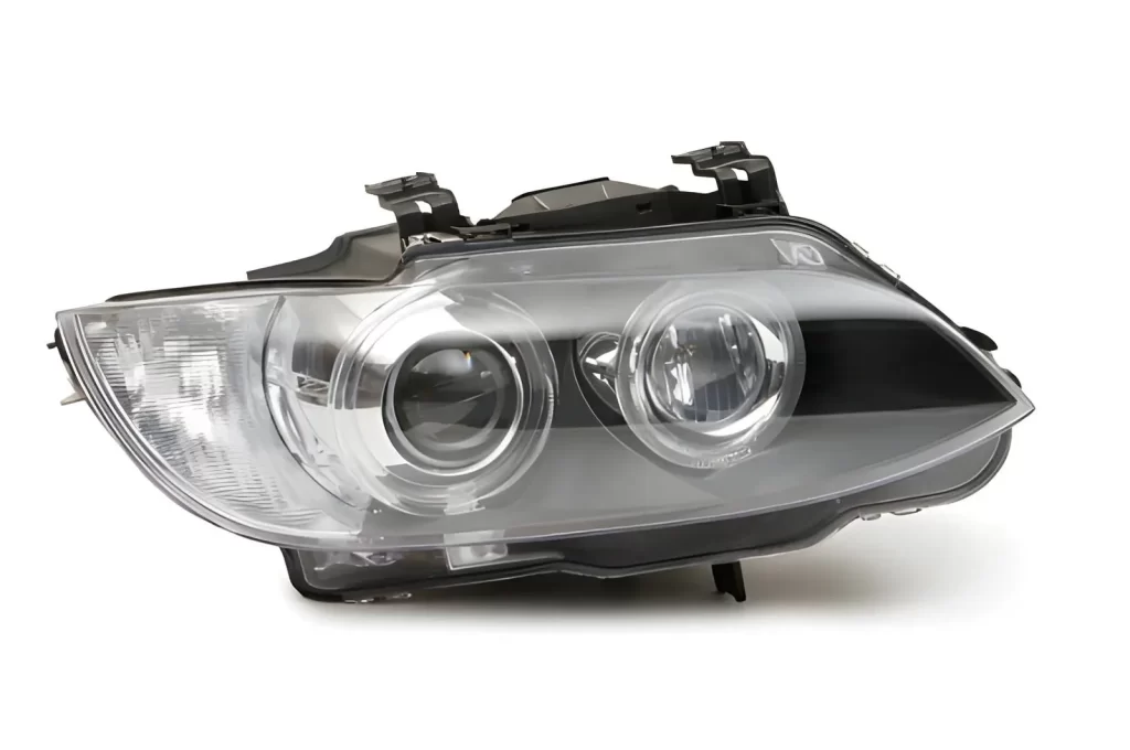 Automotive headlight assembly with a clear polycarbonate lens and plastic housing, commonly produced using injection molding.