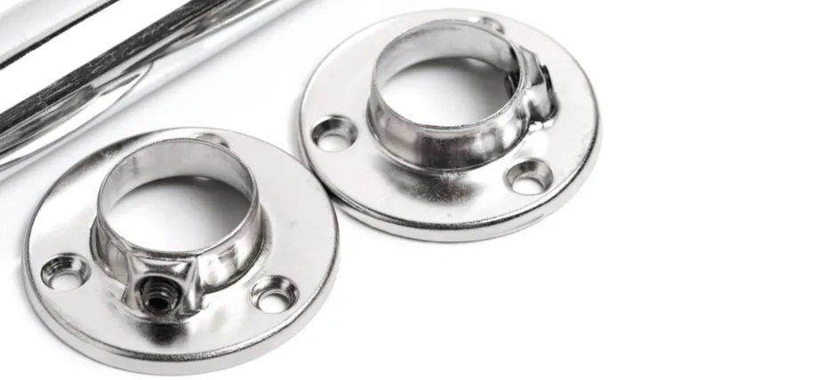 Shiny, chrome-plated metal pipe flanges and tubes illustrating the results of a high-quality electroplating finish.