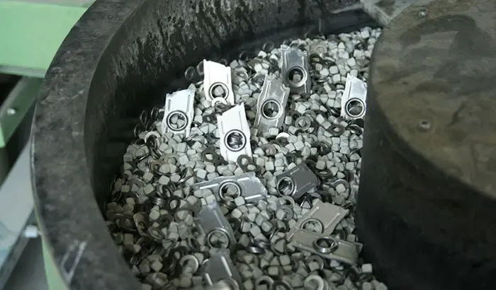 Large collection of metal gears after the metal finishing process in a barrel tumbling