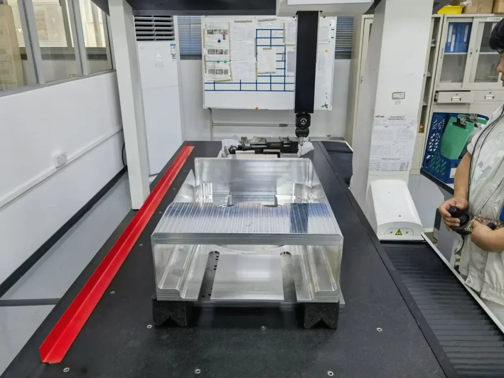 An image of a Coordinate Measuring Machine (CMM) inspecting a part using a probe for precise dimensional measurement