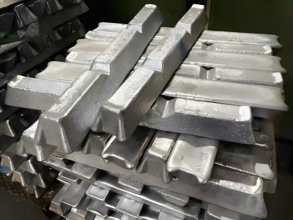 Aluminum alloy ingots stacked in the foreground.
