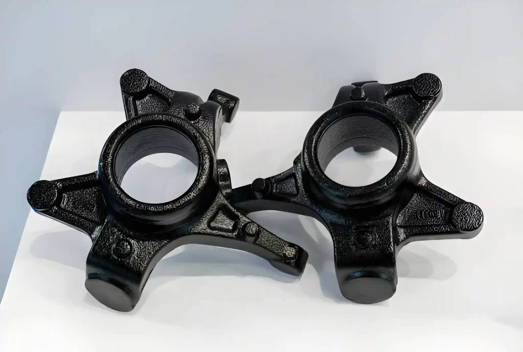 The image depicts a pair of die-cast vehicle brake brackets