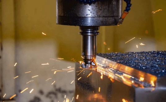 A CNC tool machining a workpiece with fire sparks 