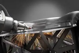 Laser cutting machine processing a metal sheet for aerospace component fabrication