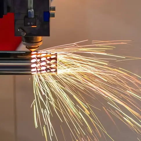 Laser cutting machine producing sparks while cutting stainless steel tube