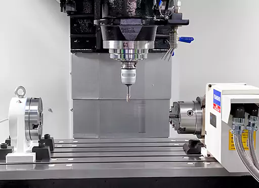 Close-up view of a 4 multi-axis CNC machine in an industrial setup