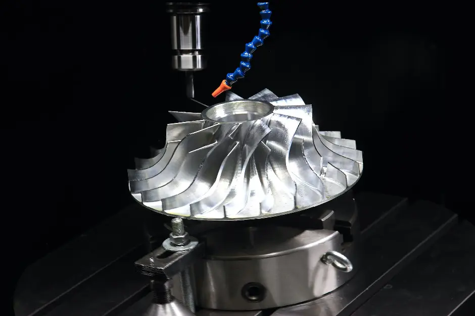 CNC machine creating a complex metallic component with a multi-axis milling tool.