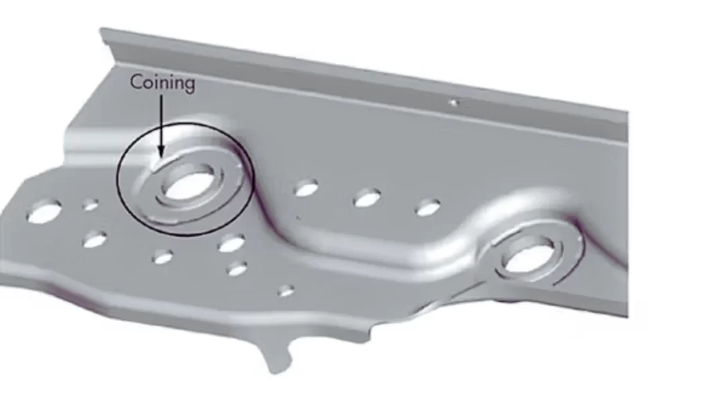 A metal part showing coining, with clear, precise impressions created on the surface through high-pressure forming.