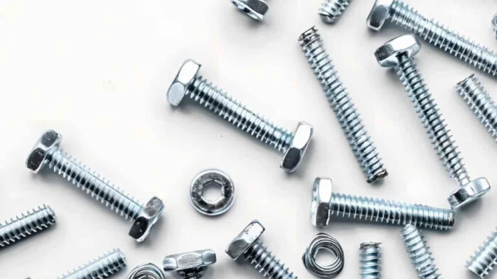 A close-up of threaded fasteners, including screws and bolts, with visible spiraled threads.