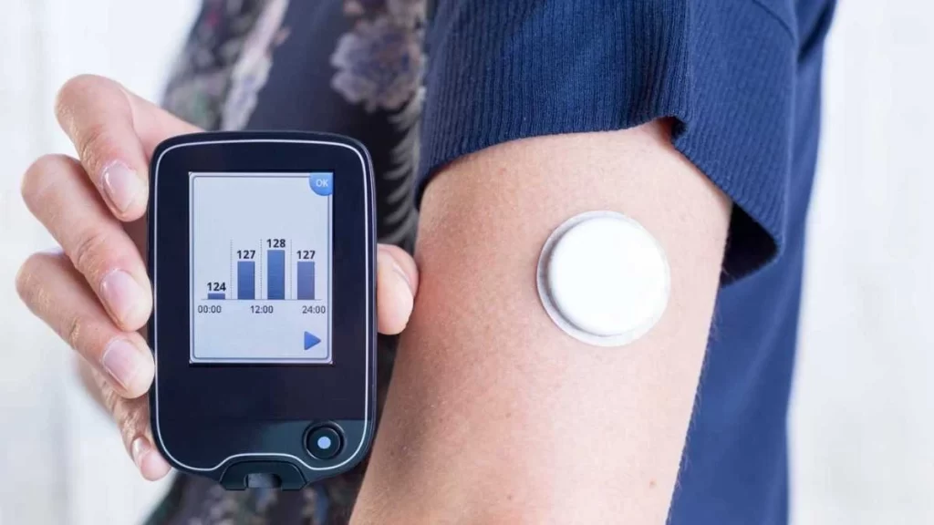 A wearable monitoring device, such as fitness tracker, designed to track health metrics like heart rate and activity levels.