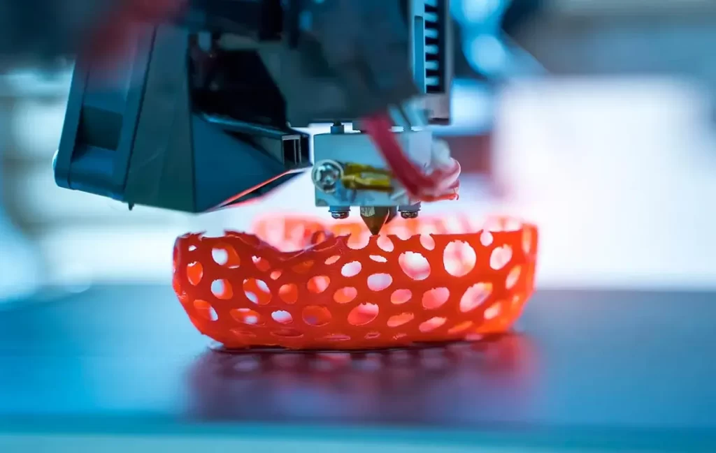 Close-up of a 3D printer creating a custom design with intricate details for automotive and industrial applications.