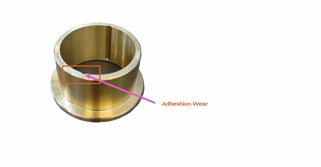 Adhesion wear on a brass bearing marked with a red rectangle.