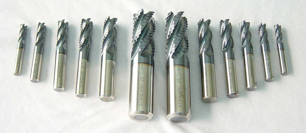 A set of 12 TiN coated end mills of varying diameters and heights