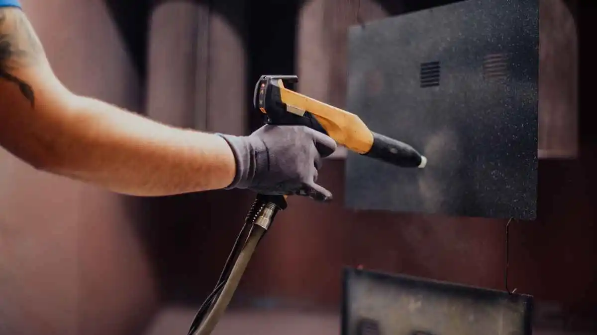 An aluminium part under abrasive treatment that leaves a uniform matte grey surface