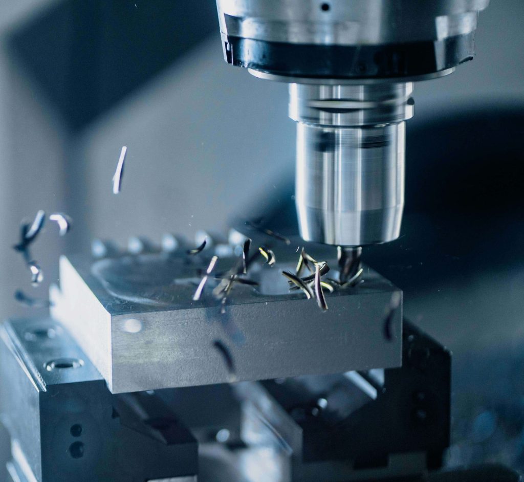 A Metal Block Being Machined By a Milling Tool