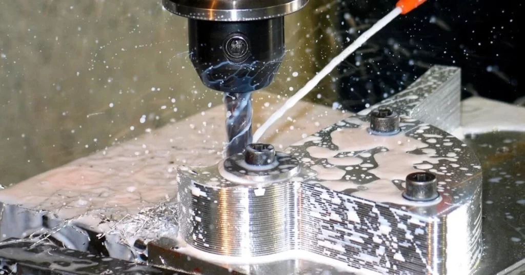 A close up view of milling machine crafting complex metal part.