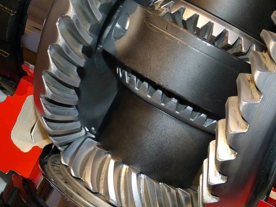 Alt text: A closeup image of helical gears, part of a car transmission system