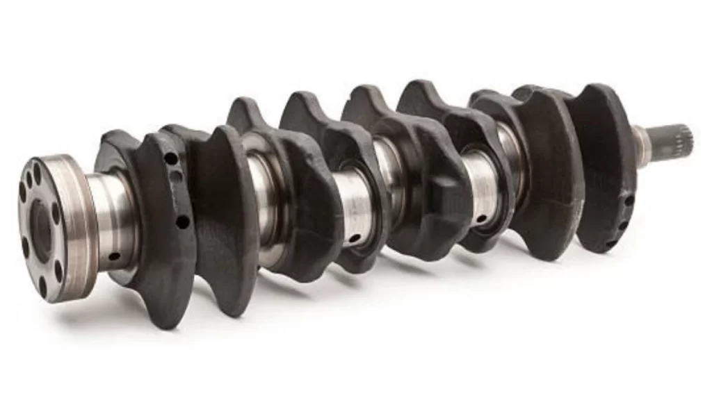 The image shows a metal crankshaft with a cylindrical design, highlighting its movement as it converts linear motion into rotation.