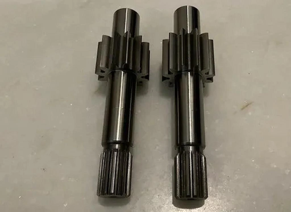 Two tool steel shafts for pump motors with smooth surface finish