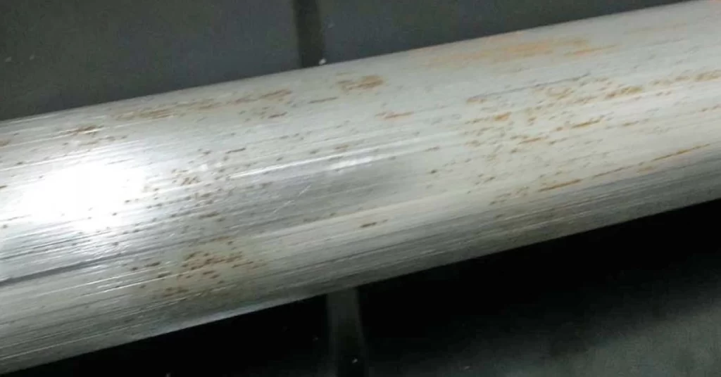 A close view of stainless steel rod with corrosion spots on surface 