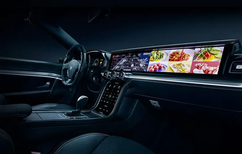 Futuristic car interior with a wide digital display and cutting-edge technology for a seamless experience.