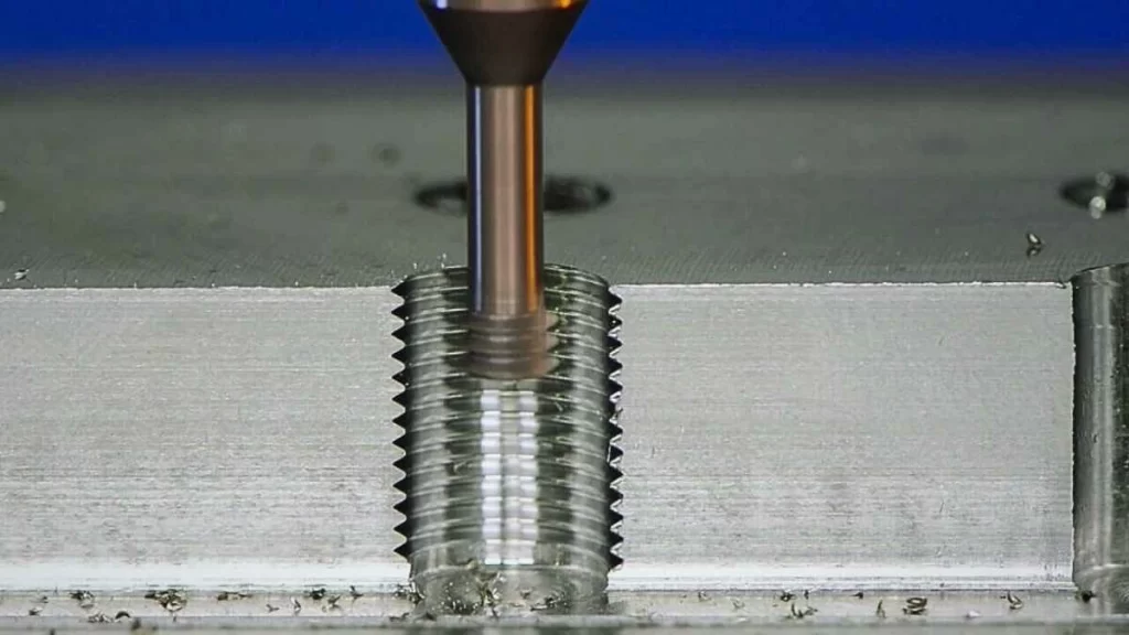 Image showing the thread milling process, where a rotating multi-point cutter creates precise internal threads on a workpiece.