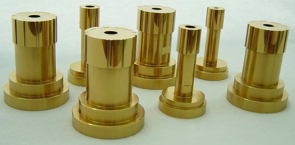 Seven TiN-coated cylindrical punches of varying diameters, gold-colored and shiny