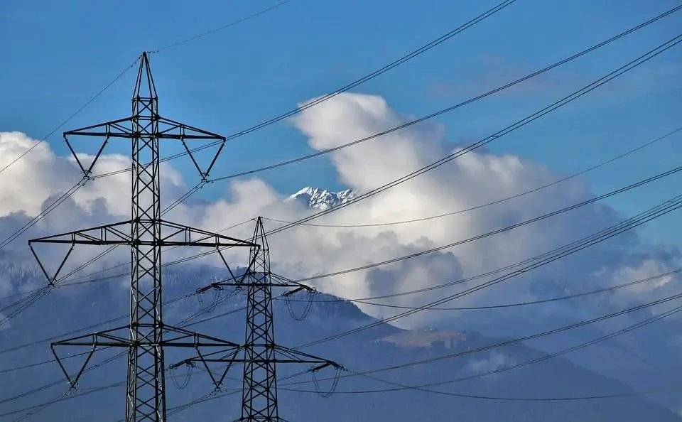 Two power transmission towers alongside each other with their conductors running parallel  