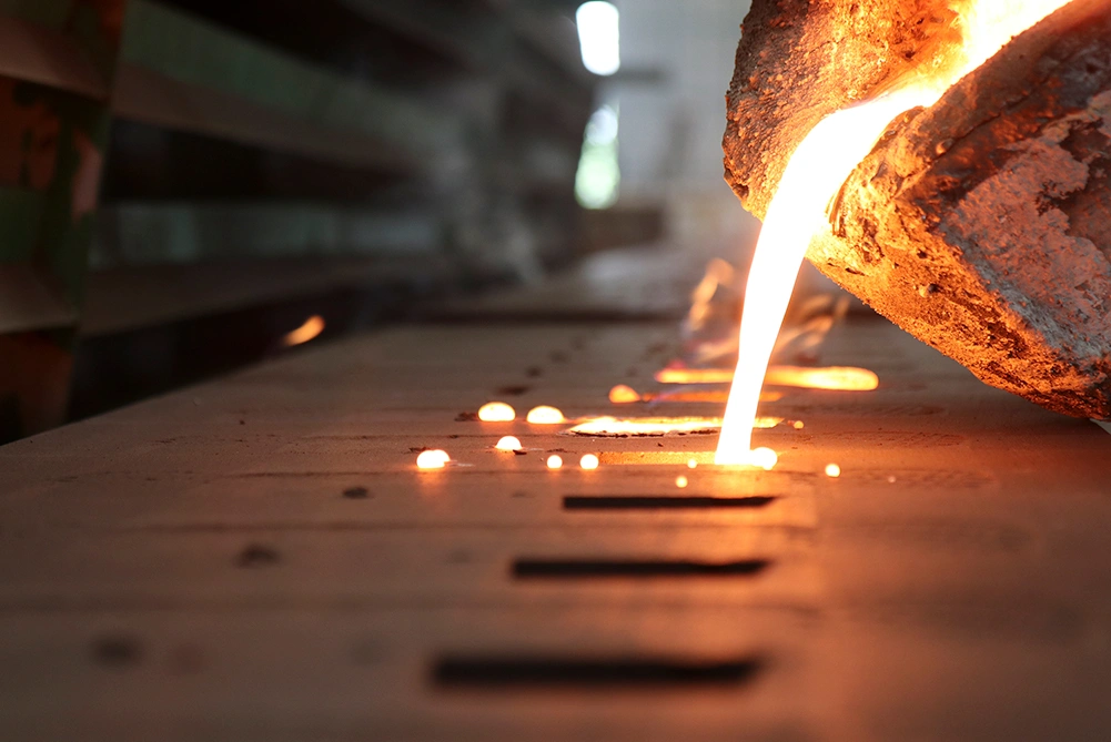 A close up view of pouring molten metal in die cavity 