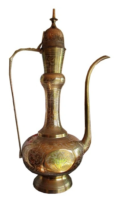 A long-spouted brass pot with decorative engravings 